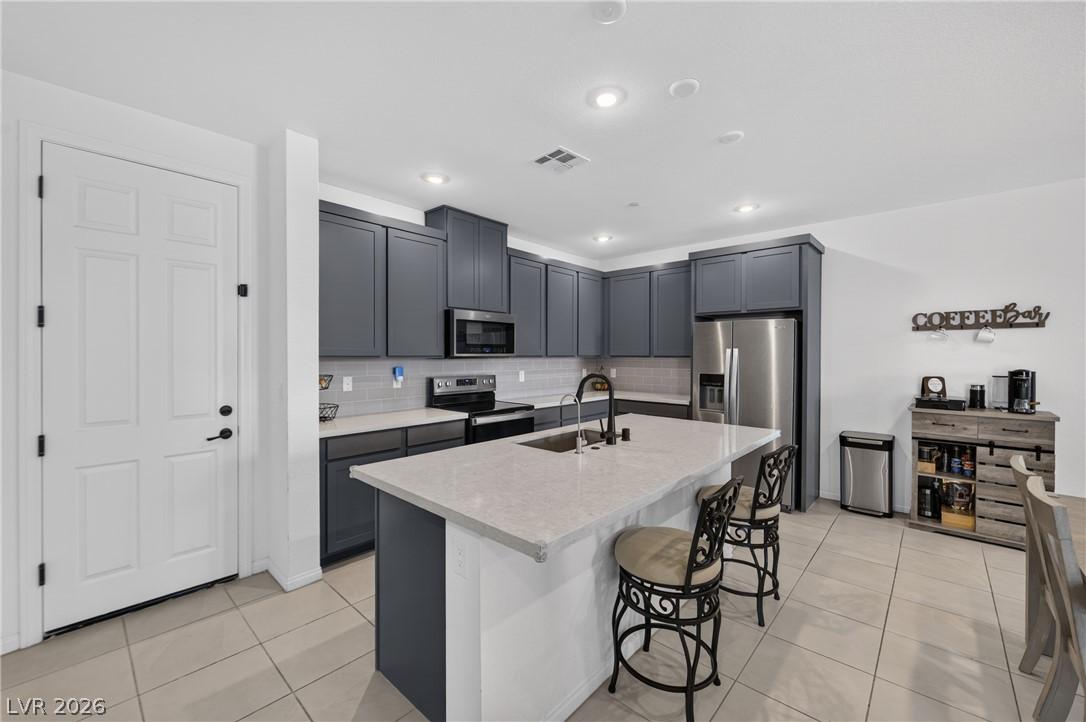 Image 3: A contemporary kitchen showcasing dark cabinetry,