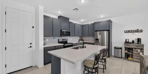 Image 3: A contemporary kitchen showcasing dark cabinetry,