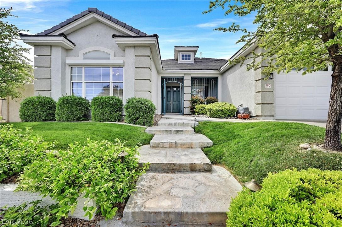 Image 2: A neatly manicured lawn frames the inviting entryw