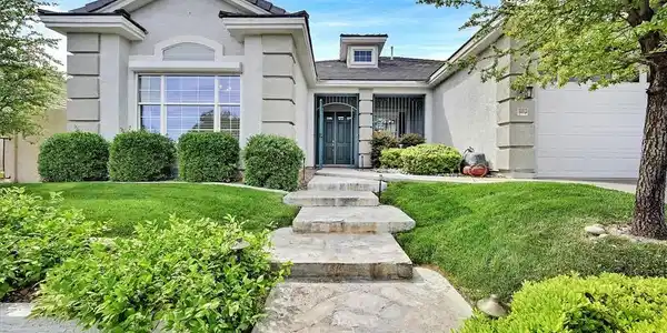 Image 2: A neatly manicured lawn frames the inviting entryw