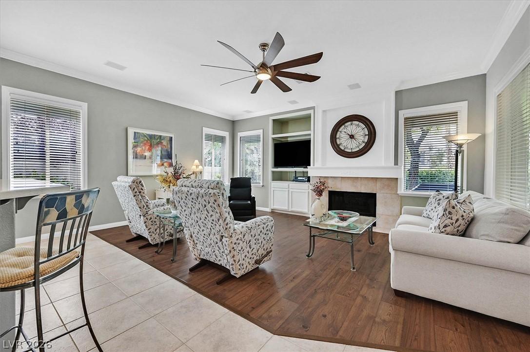 Image 3: An inviting family room boasts rich wood flooring