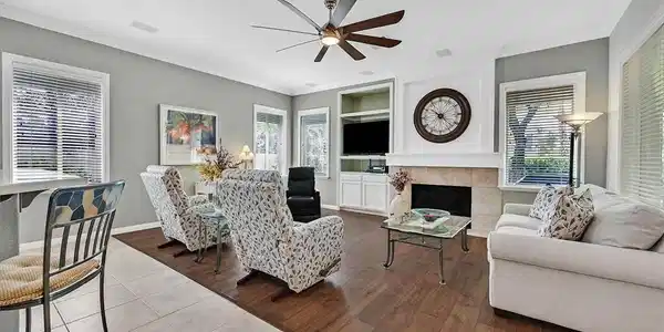 Image 3: An inviting family room boasts rich wood flooring