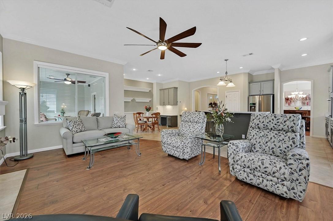 Image 4: An open-concept living space with lustrous hardwoo
