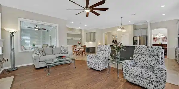Image 4: An open-concept living space with lustrous hardwoo