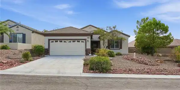 Image 3: An attached two-car garage sits beside desert land