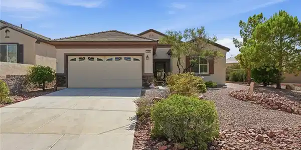 Image 4: Desert landscaping and a concrete driveway lead to