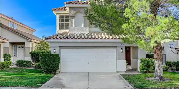 Image 3: Spanish tile roofing and a two-car garage define t