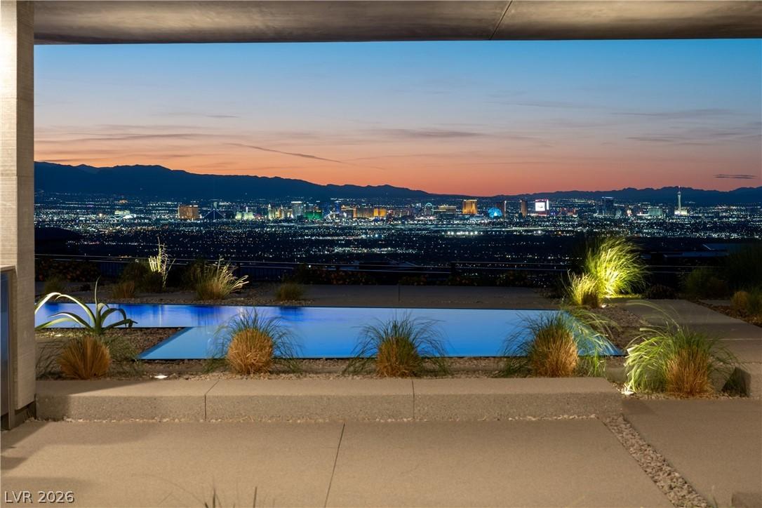 Image 3: This outdoor oasis presents a tranquil pool with c