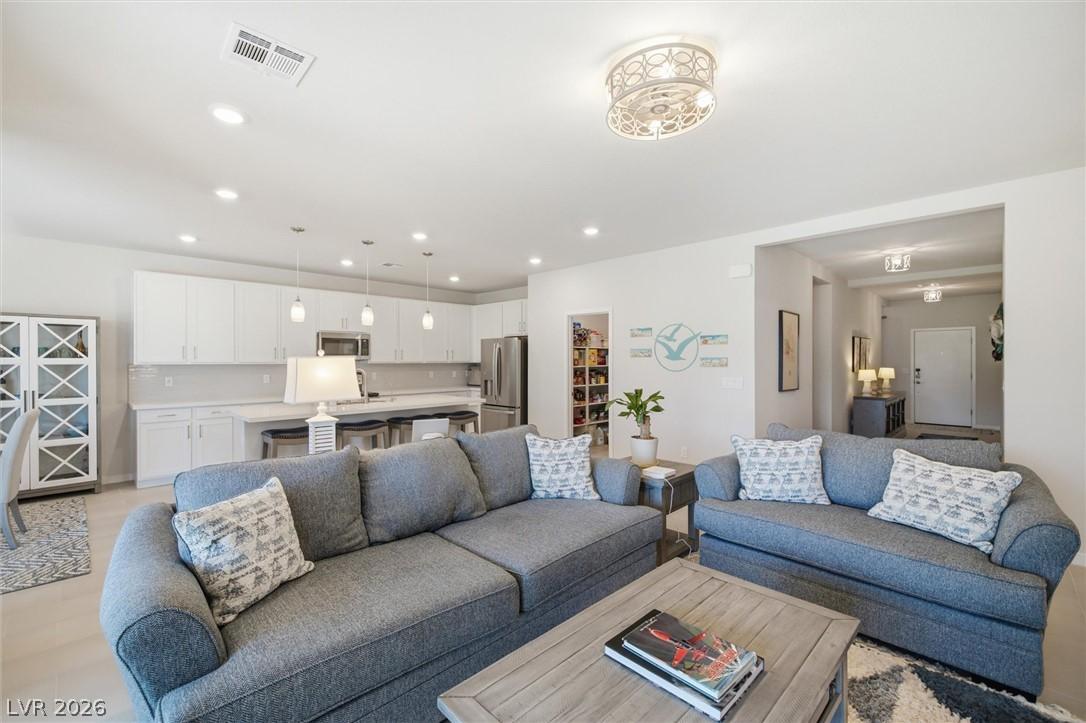 Image 2: An open concept living area seamlessly flows into