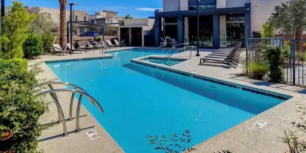 Image 2: An inviting swimming pool and integrated spa sit a