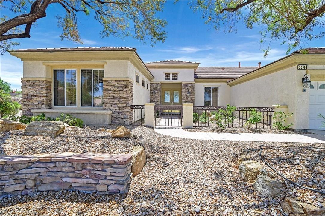 Image 2: View of front of property featuring stucco siding,