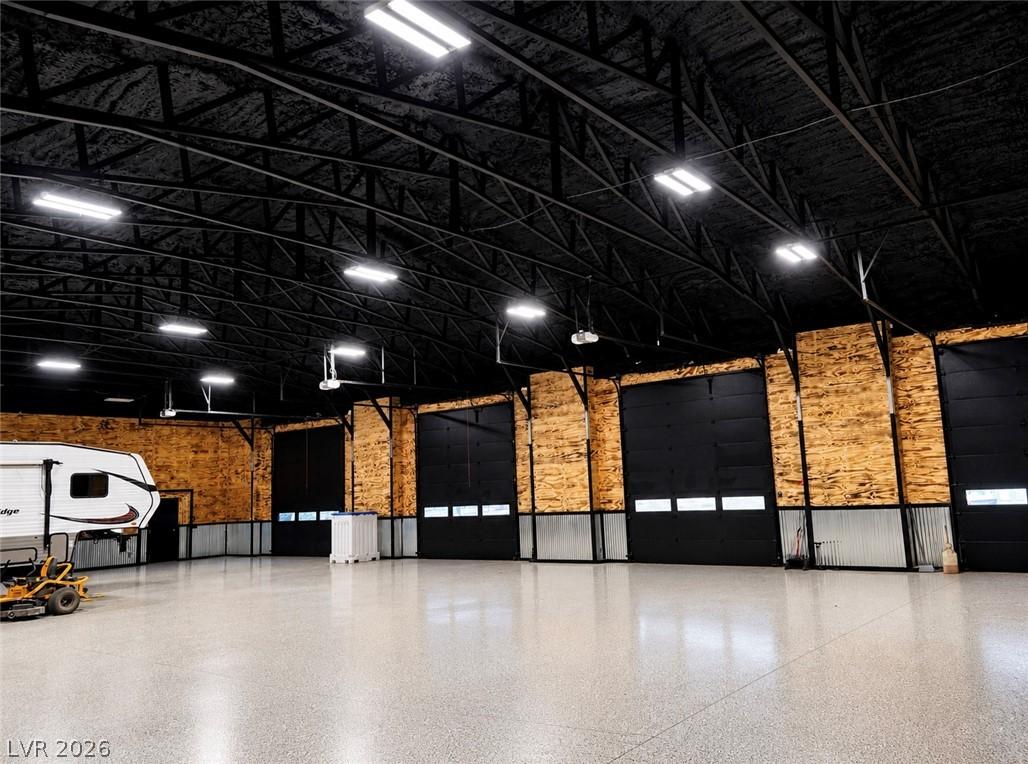 Image 3: A spacious, well-lit garage with multiple large ro