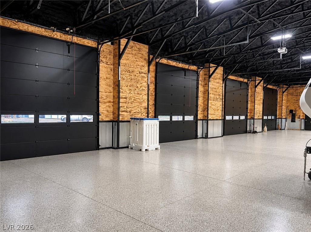 Image 4: A spacious garage with multiple bay doors, ideal f