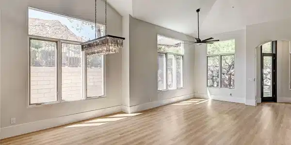 Image 3: Angled ceilings and tall windows elevate this open