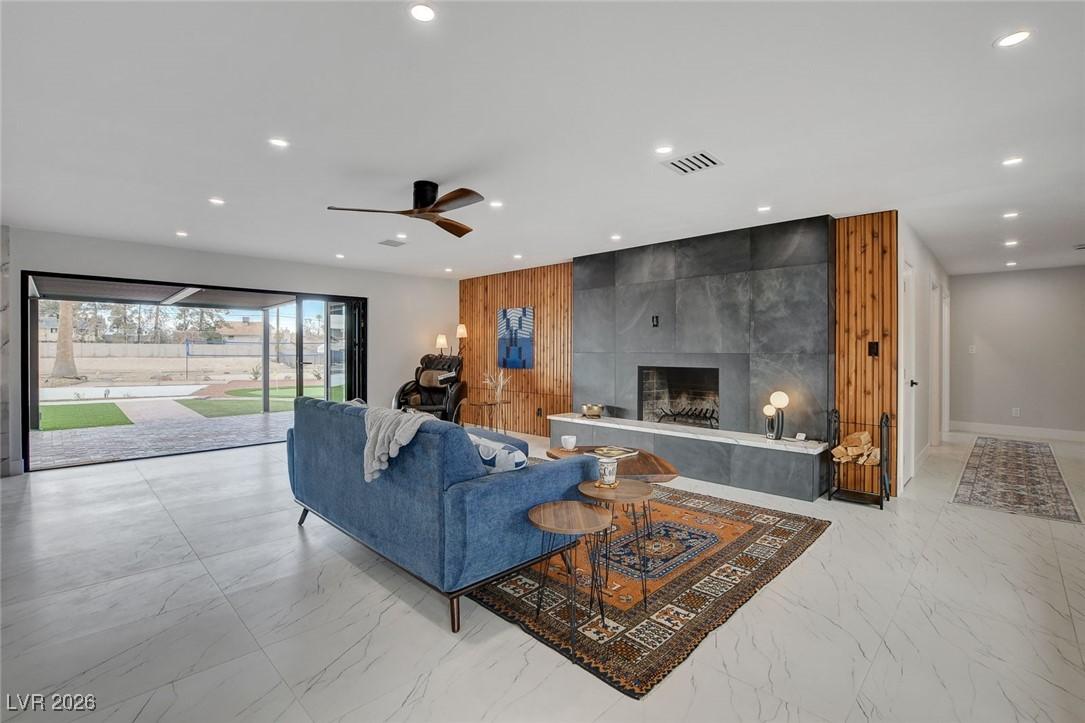 Image 2: Living room with fireplace and accordion door to p