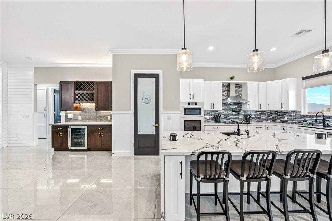 Image 4: Marble-look countertops grace a generous kitchen i