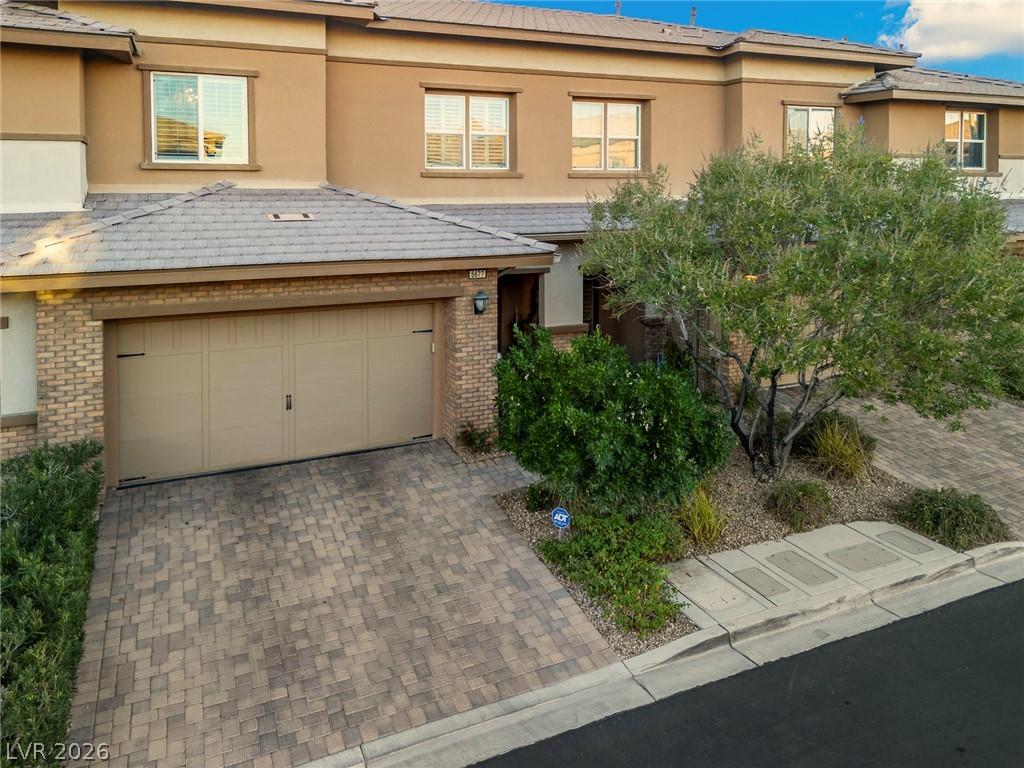 Image 3: A welcoming front entrance features a paver drivew