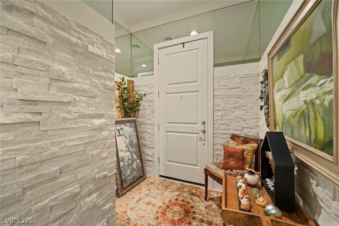 Image 4: A welcoming entryway with textured stone walls and