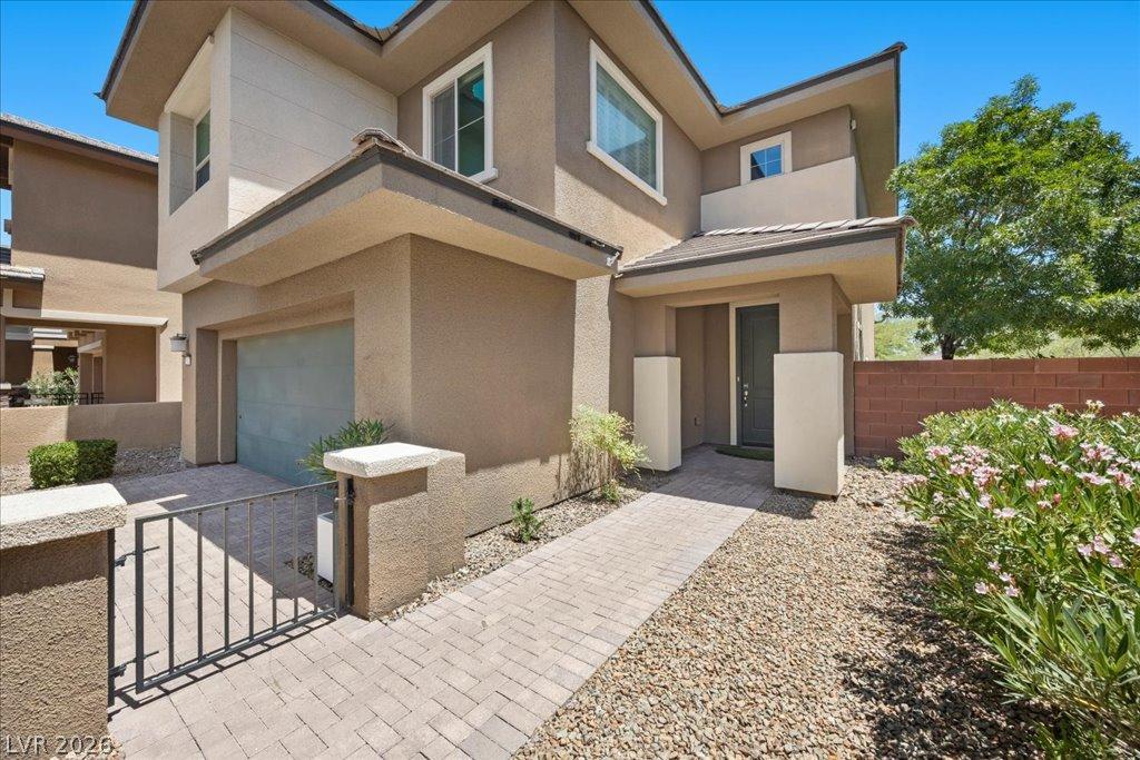 Image 3: A contemporary exterior welcomes with a paver path