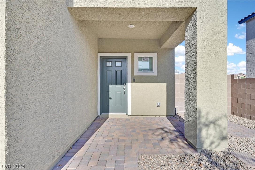 Image 2: A welcoming entry featuring paver flooring and a c