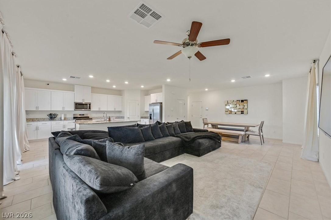 Image 3: An open-concept interior unites living, dining, an