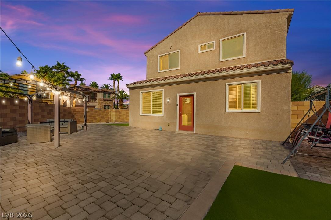 Image 2: A private backyard oasis features extensive paver