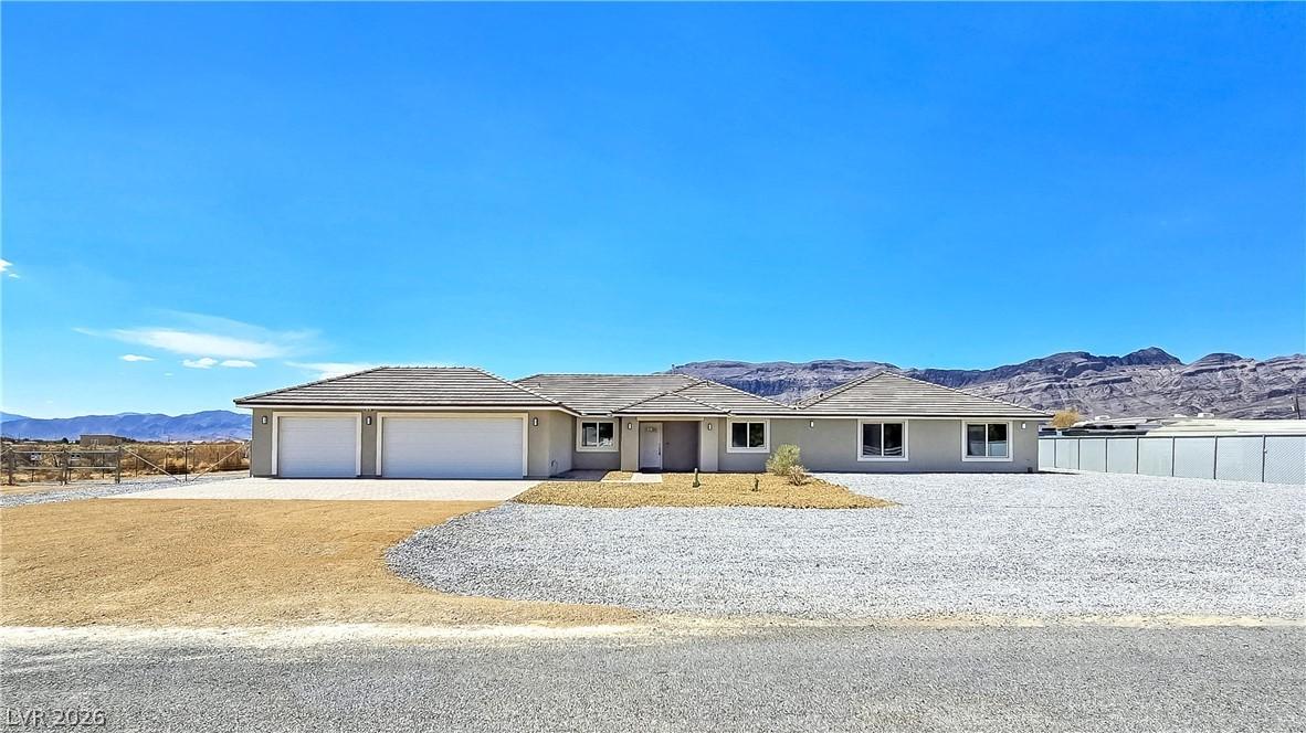 Image 1: A well-maintained stucco residence offers ample pa