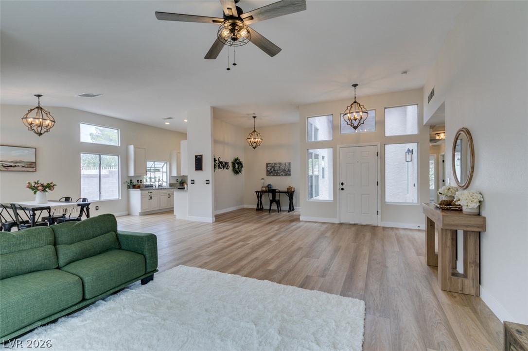 Image 1: Natural light illuminates this open-concept living