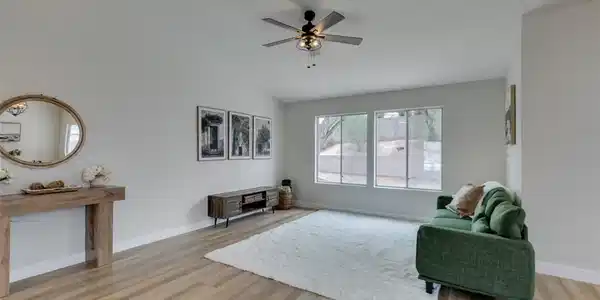 Image 2: Natural light floods this inviting living space, h