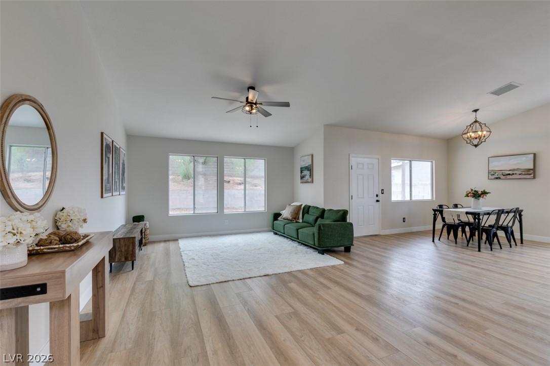 Image 3: An airy living space with vaulted ceilings, well-l