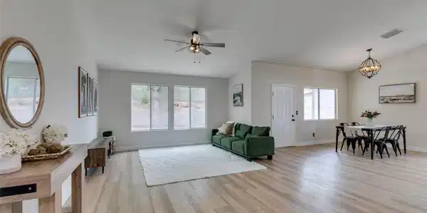 Image 3: An airy living space with vaulted ceilings, well-l