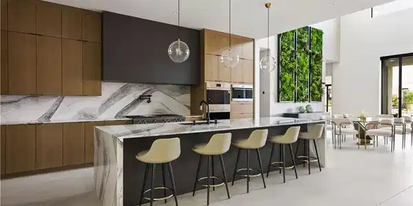 Image 2: Marble waterfall island with a sleek cooktop ancho