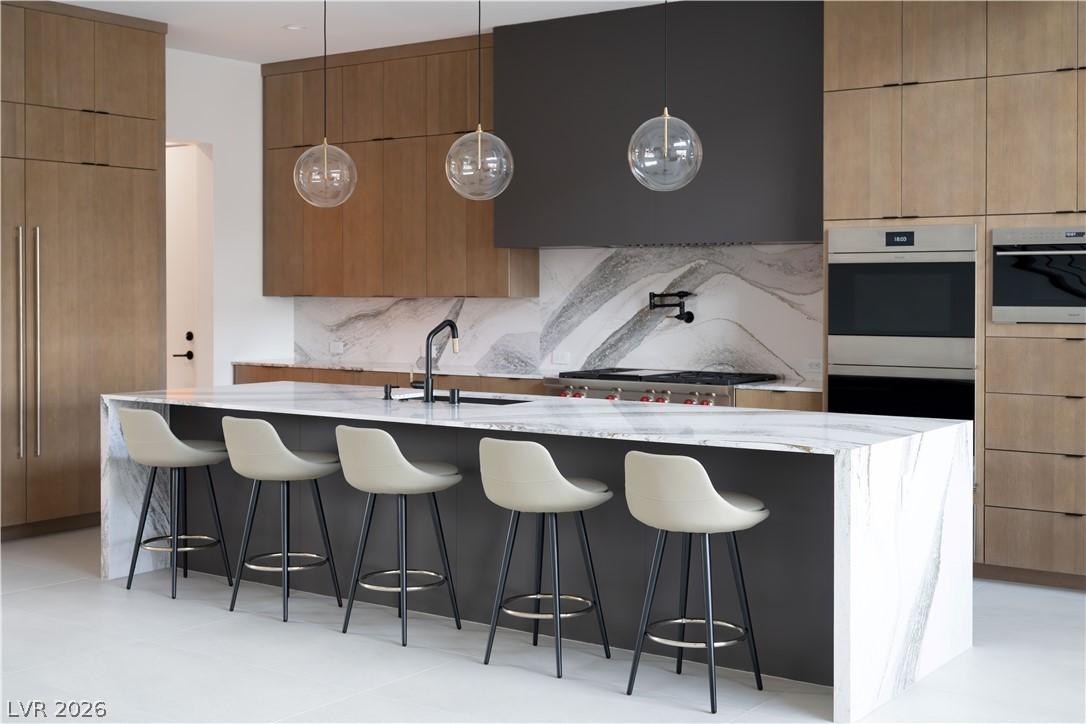 Image 4: Culinary delights await in this sleek kitchen feat