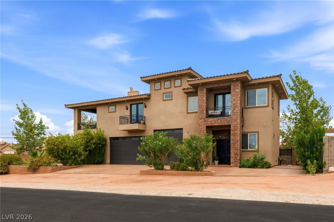 Image 2: Front exterior which includes 2 car garage and RV