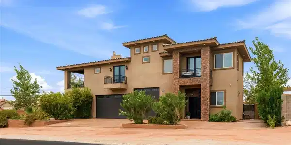 Image 2: Front exterior which includes 2 car garage and RV