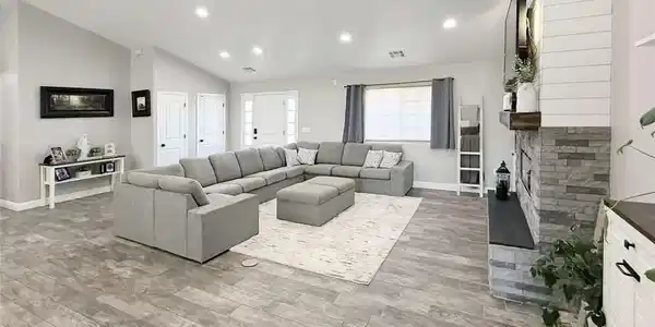 Image 3: Recessed lighting illuminates a spacious living ro