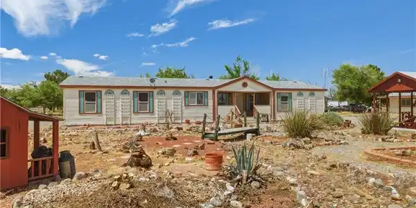 Image 2: A well-maintained manufactured home nestled in a s