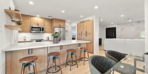 Image 4: Gleaming hardwood floors and a spacious kitchen is