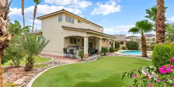 Image 2: Lush landscaping and a refreshing pool define this