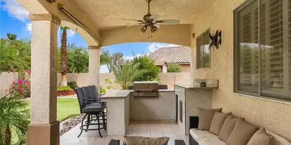 Image 4: An inviting outdoor living space features barbecue