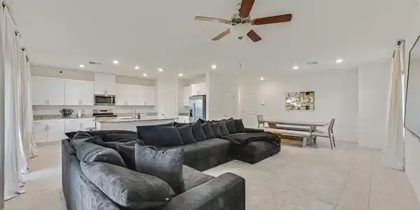 Image 3: An open-concept interior unites living, dining, an