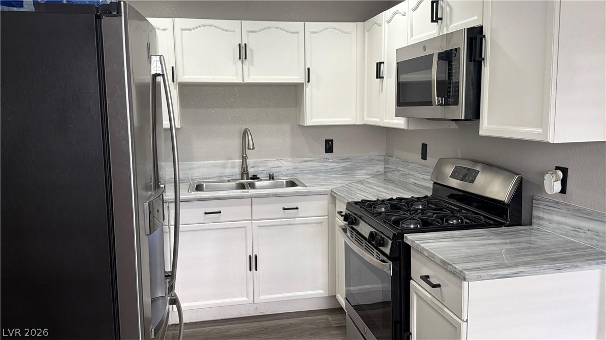 Image 4: A contemporary kitchen features sleek countertops,