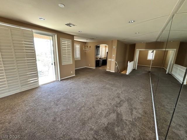Image 4: Unfurnished living room with arched walkways and d