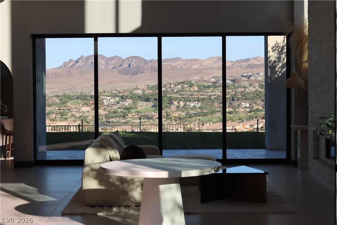 Image 3: Floor-to-ceiling windows frame sweeping mountain a