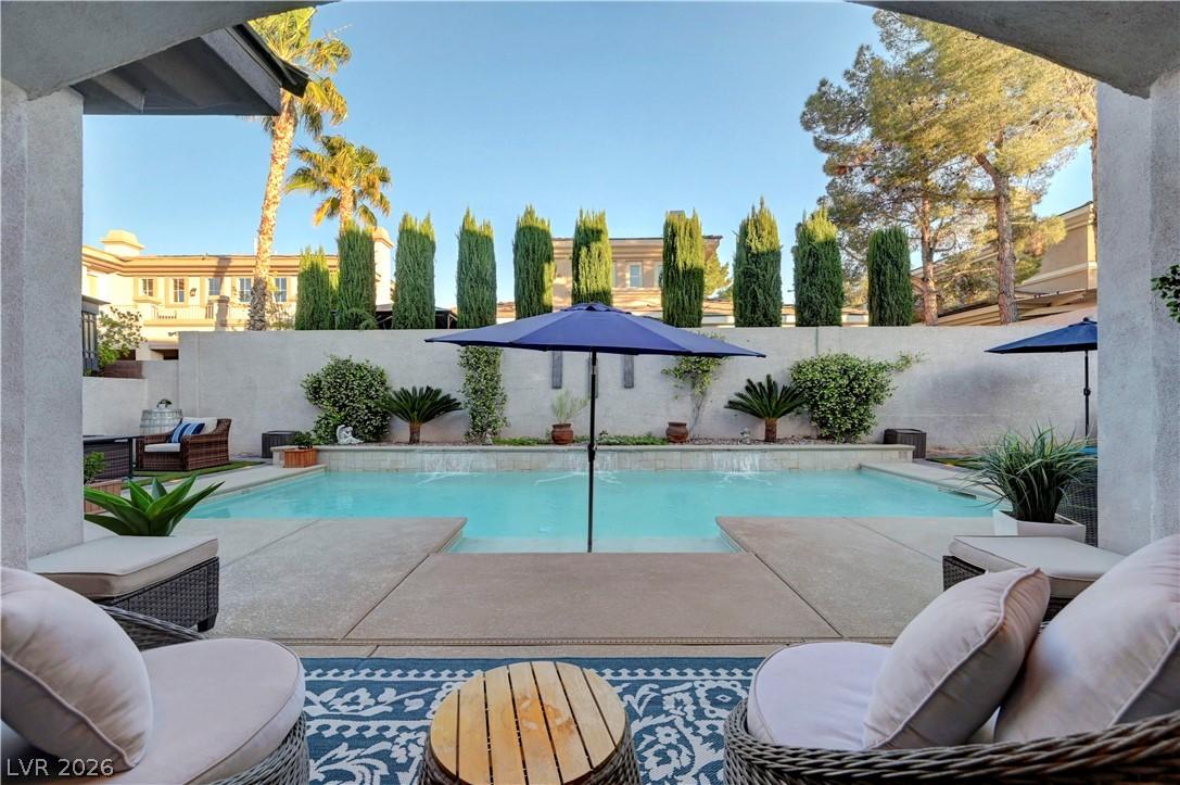 Image 3: This tranquil outdoor area features a sparkling po