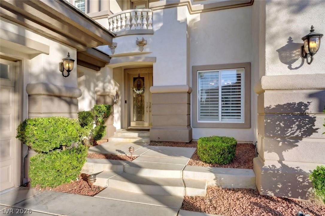 Image 4: The welcoming entrance features elegant outdoor li