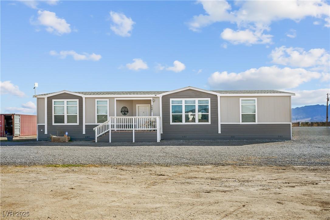 Image 1: View of front of home with covered porch