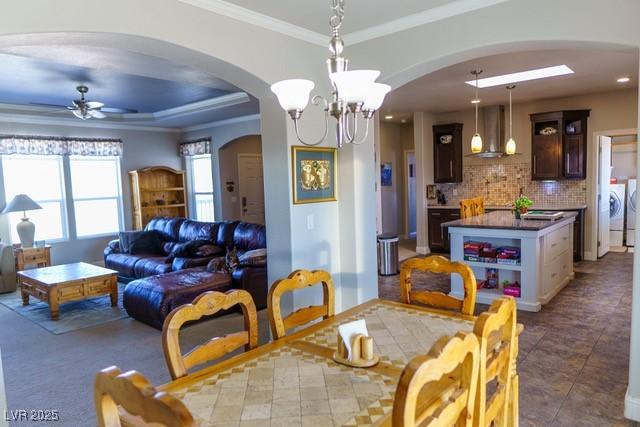 Image 4: Dining area featuring arched walkways, a raised ce