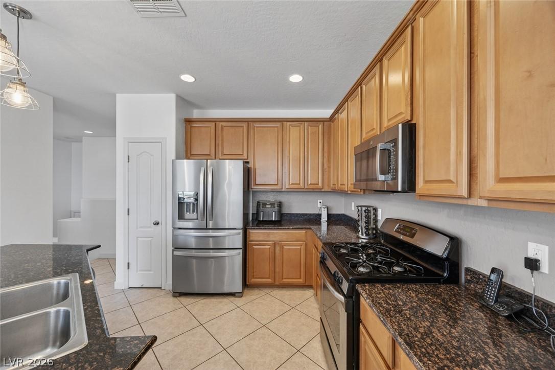 Image 3: This spacious kitchen features ample cabinetry, mo