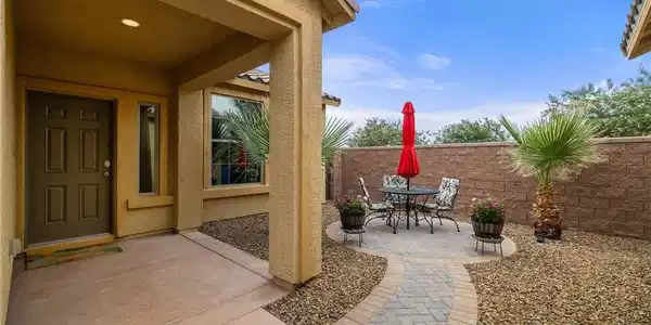 Image 4: This charming entrance features a private patio pe
